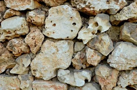 Wall of large stones. The texture of light sandstone. Stock Photos