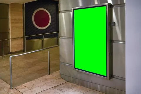 Wall with light display ad board - green color advertisement mock up, steel.. Stock Photos