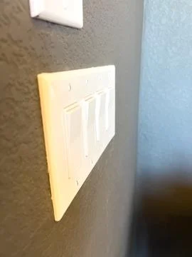 Wall Light Switch On Textured Dark Wall Stock Photos