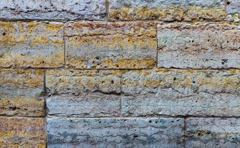 A wall of limestone blocks covered with dirt and remains of paint Stock Photos