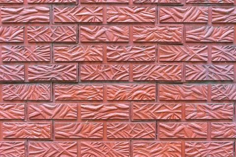 The wall is lined with red tiles with a brick texture Stock Photos