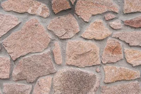 A wall lined with stone as a background 스톡 사진