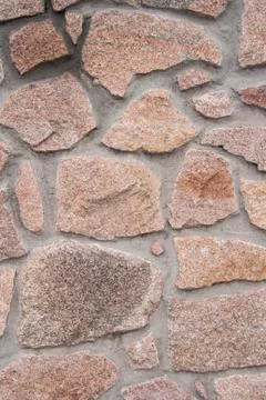 A wall lined with stone as a background Stock Photos
