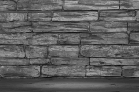 The wall is made of bricks of black and white color and wooden boards with a Stock Photos