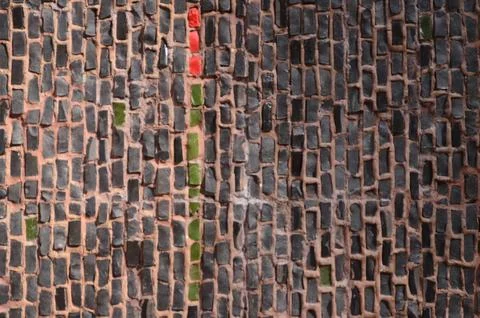 A wall made of bricks with a red line in the middle. Stock Photos