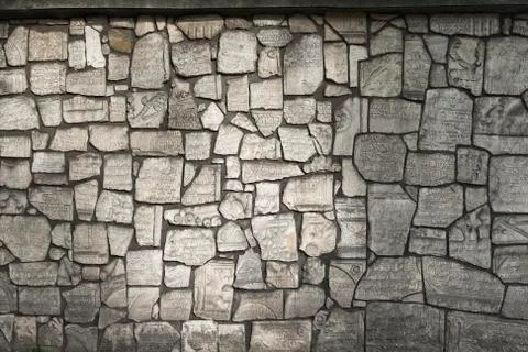 The wall is made from fragments of monuments Stock Photos