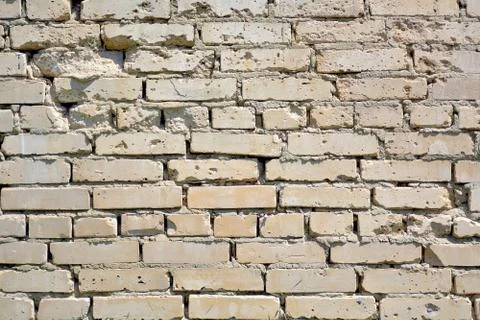 The wall is made of gray bricks with potholes.	 Stock Photos