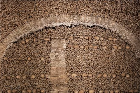 The wall made of human bones and skulls Stock Photos