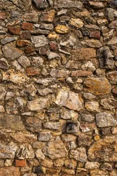 A wall made of large rocks and cement, great for a background or wallpaper Stock Photos