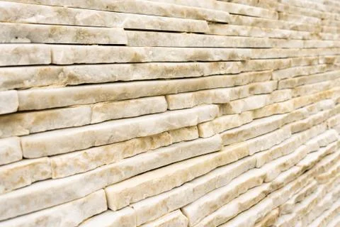 The wall is made of light marble, marble bricks lying on top of each other Foto stock