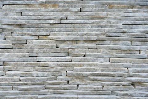 The wall is made of light marble, marble bricks lying on top of each other Foto stock