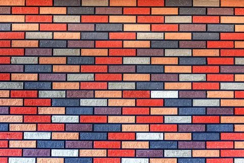 Wall made of multi-colored bricks. Bricks background. Abstract texture Stock Photos