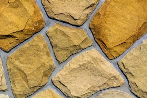 Wall made of natural limestone. Irregular stones surface. Seamlessr old stone Stock Photos