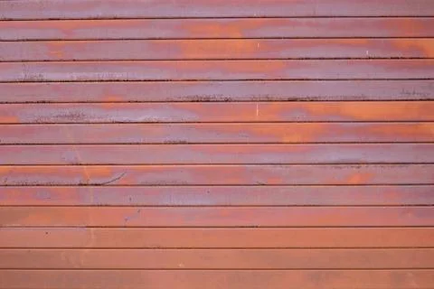 The wall is made of old rusty metal. Stock Photos