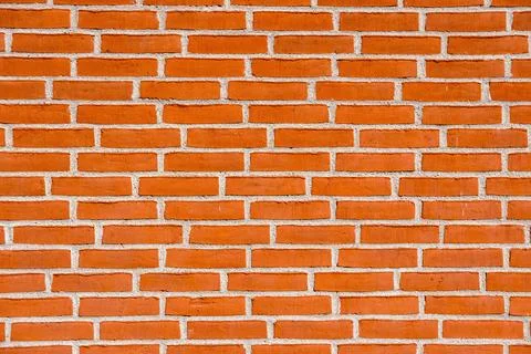 Wall made of orange bricks Stock Photos