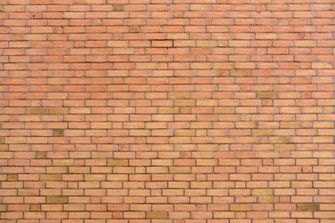 Wall made of orange clinker bricks Stock Photos
