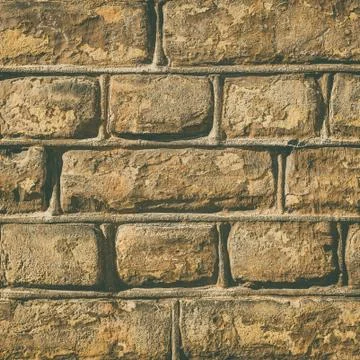 Wall made out of brown rectangular stones Stock Photos