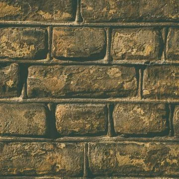 Wall made out of brown rectangular stones Stock Photos