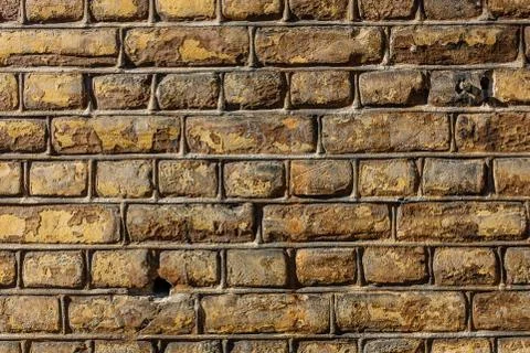 Wall made out of brown rectangular stones Stock Photos