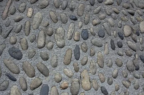 The wall is made of oval cobblestones of different sizes.Texture or backgroun Stock Photos