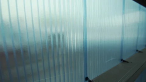 Wall made of polycarbonate hollow sheets with wooden bars Stock Footage 231721696