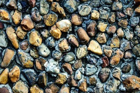 A wall made of rocks with a brown and gray color Stock Photos