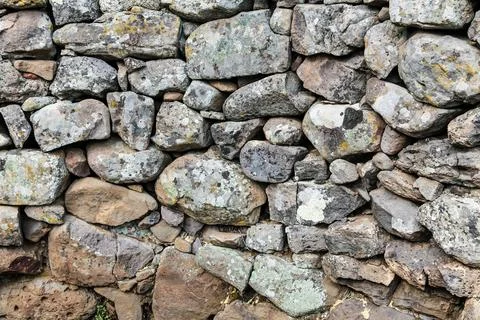A wall made of rocks with moss growing on it An ancient stone gate building.. Stock Photos