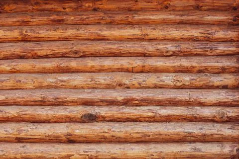 Wall made of round logs without bark Stock Photos