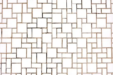 Wall made of square and rectangular white mosaic tiles 스톡 사진