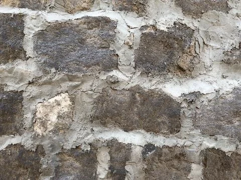 A wall made of stone and cement Stock Photos
