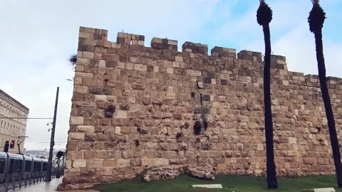 A wall made of stone blocks with a building in the background. Jerusalem ol.. Stock Footage 325132561