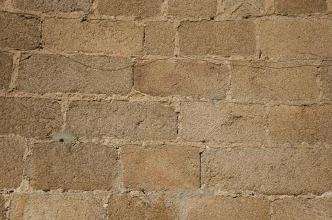 Wall made of stone bricks, forming a charming pattern at Caceres Foto stock
