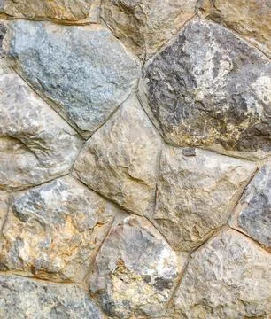 A wall made of stone with a pattern of squares Stock Photos