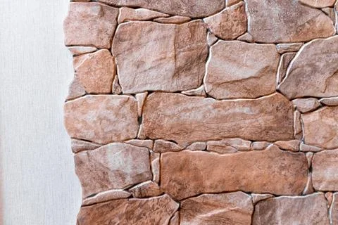 A wall made of stone with a rough texture Stock Photos