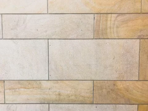 Wall made of tan bricks with a white border Stock Photos