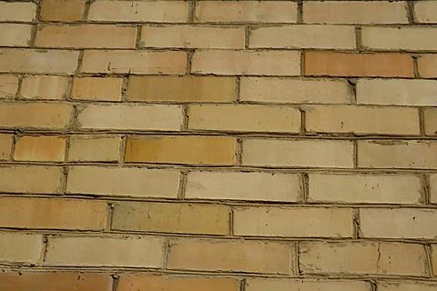 A wall made of yellow brick, capable of serving as a background. Foto stock