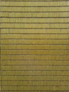 A wall make of brass casings from automatic rifle. Fragment of the installa.. Stock Photos