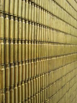 A wall make of brass casings from automatic rifle. Stock Photos