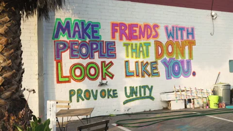 On A Wall: "Make Friends With People That Don’t Look Like You. Provoke Unity" Stock Footage 139033727