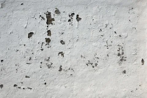 A wall with marks and uneven texture is shown Fotos de archivo