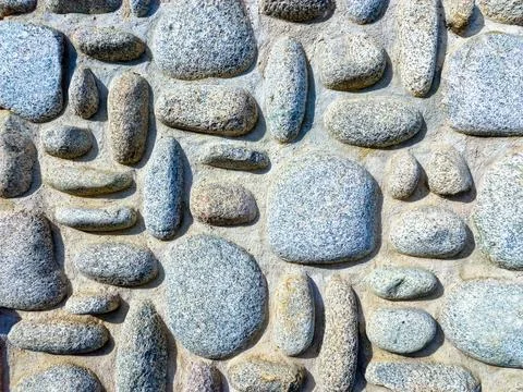 Wall masonry with river stone. stone texture background Stock Photos