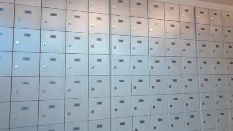 Wall of metallic silver mailboxes with numbered labels Stock Footage 321673092