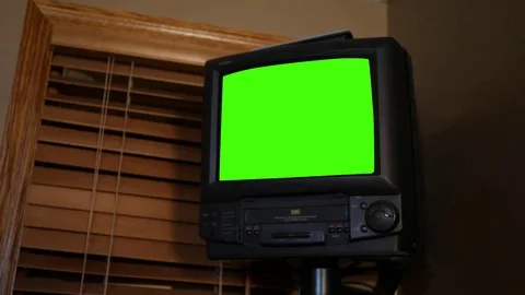 Wall Mount Green Screen VHS TV from the 1990s on wall in office Stock Footage 81632503