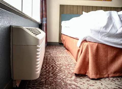 Wall mounted air conditioner unit in a room. Stock Photos