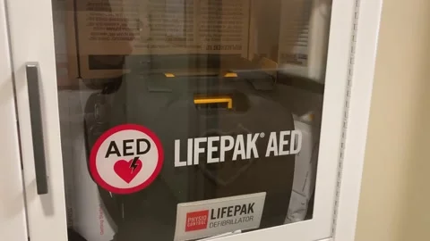 A wall mounted automated external defibrillator (AED) machine in the USA Video stock 232625539