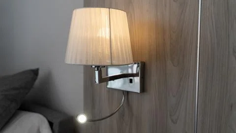 Wall Mounted Bedside Lamp in Hotel Room Interior Stockfoto's