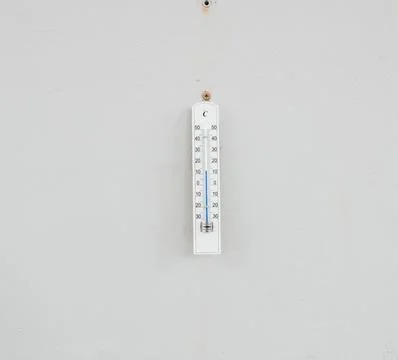 Wall-Mounted Celsius Thermometer Displaying Temperature on White Background Stock Photos
