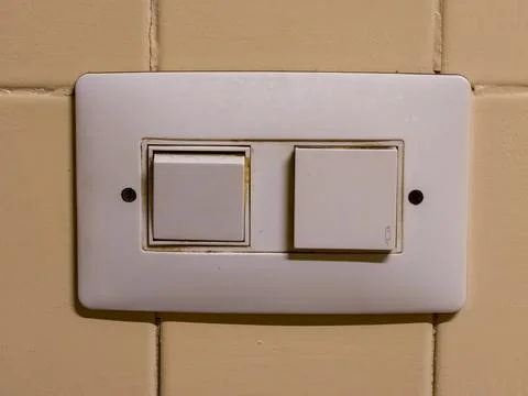 Wall mounted electrical light switch and doorbell Fotos de archivo