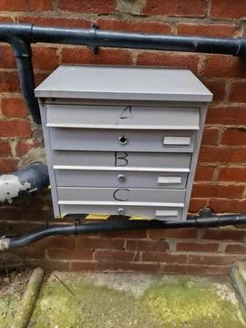 Wall-Mounted Multibox Apartment Mailboxes on a Brick Exterior Stock Photos