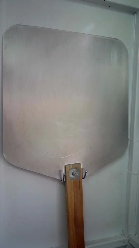 Wall-mounted pizza peel Stock Footage 298724611